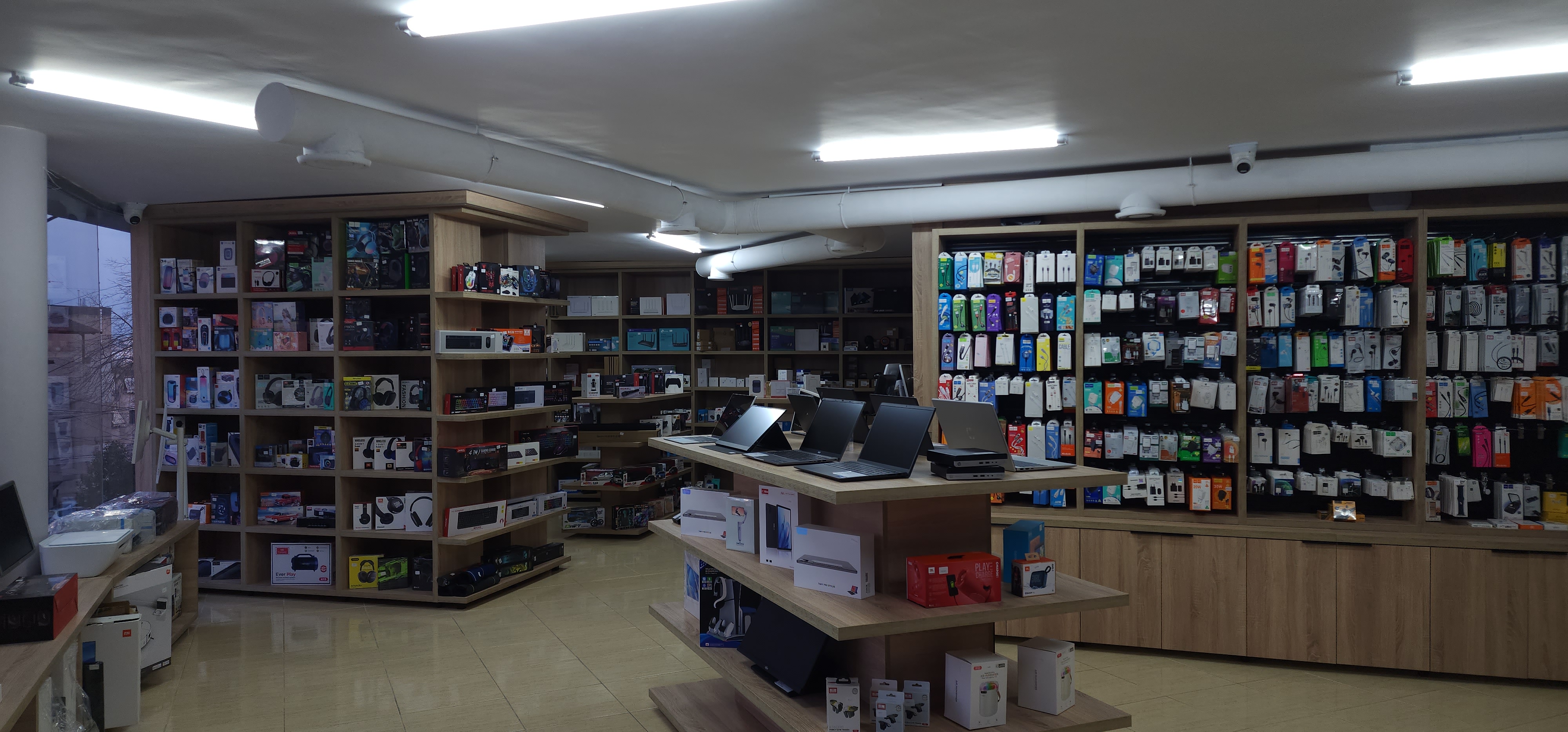 K2J Tech store interior showing shelves of tech products